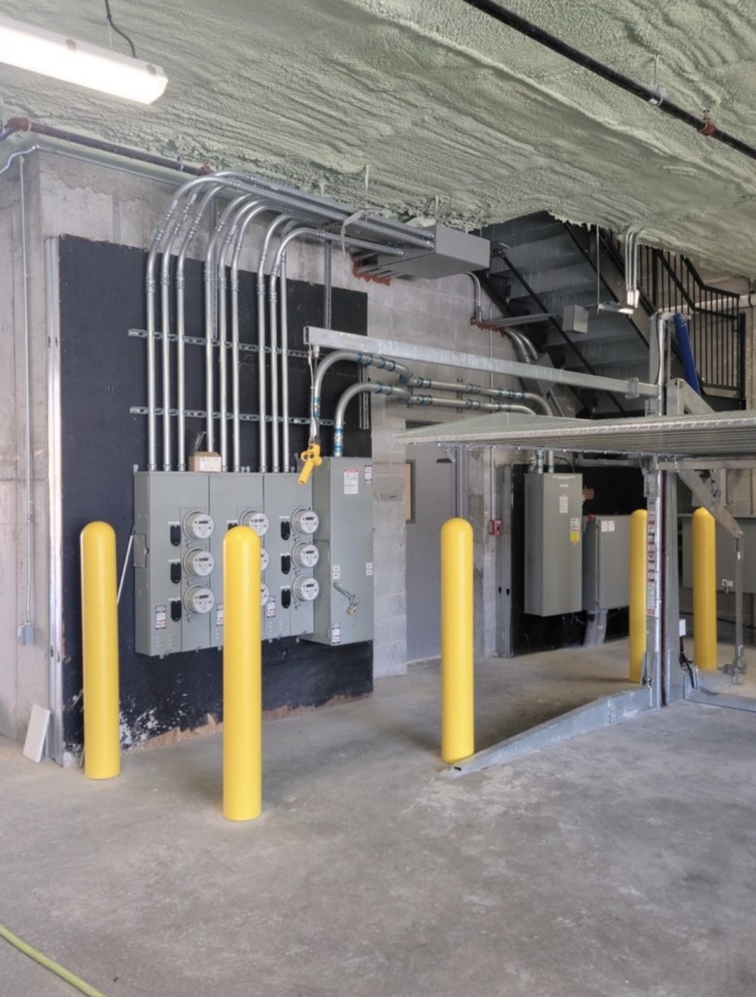 Commercial electrical service room with meter bank and conduit runs