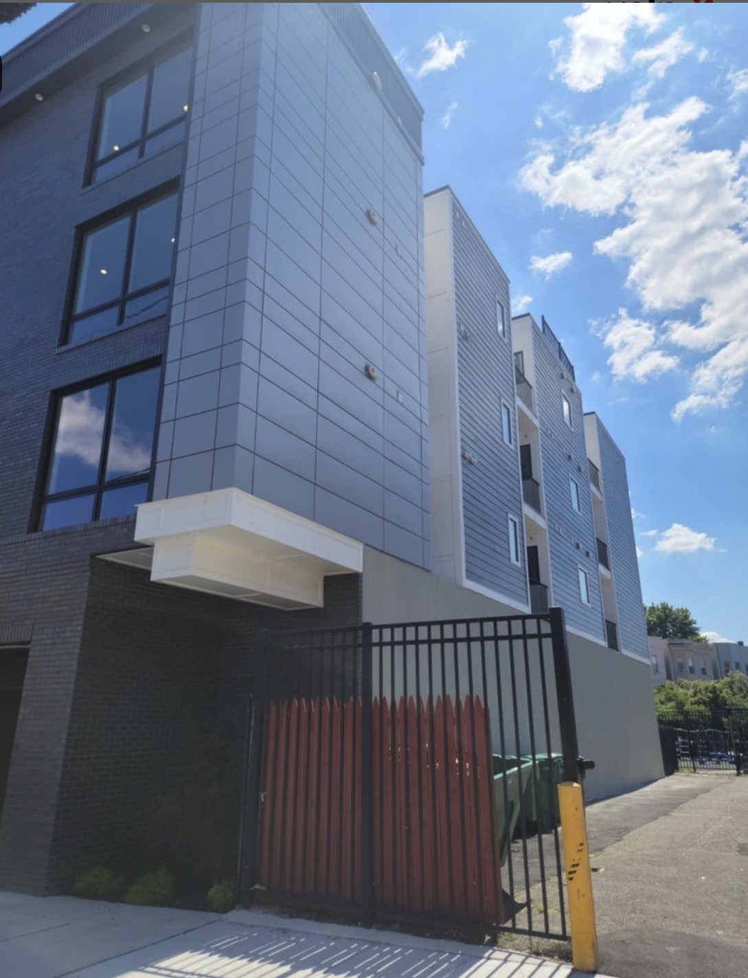 Multi-family building exterior with metal panel and siding facade