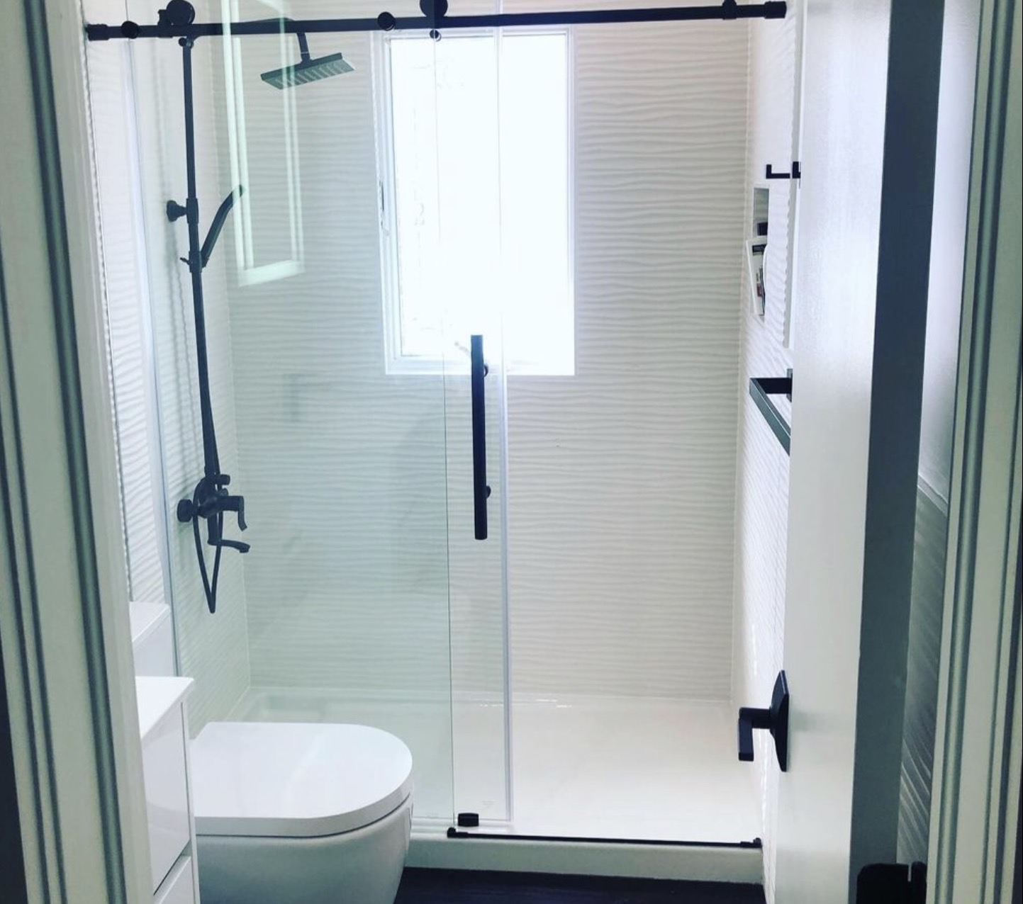 Compact bathroom renovation with sliding glass shower door
